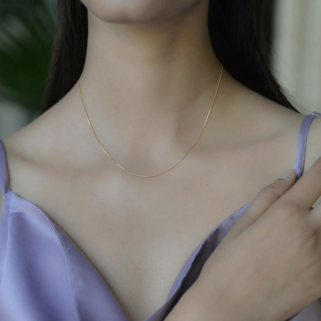 9K solid gold twisted box chain necklace in yellow or white gold. A sleek, polished, light-catching chain that adds timeless elegance to everyday style.