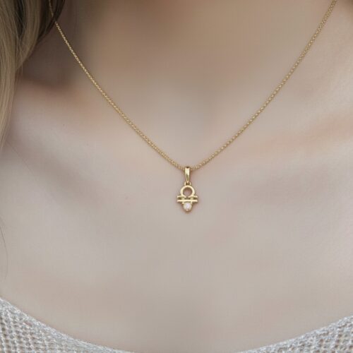 Celebrate duality with this 10K solid gold Gemini pendant in Au 417, featuring the Twins symbol and natural pearl birthstone. Elegant zodiac jewelry.