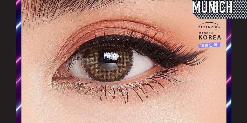 Dreamcolor Almond Brown colored contacts on dark eyes showing warm golden-brown coverage with multi-tonal pigment for natural depth