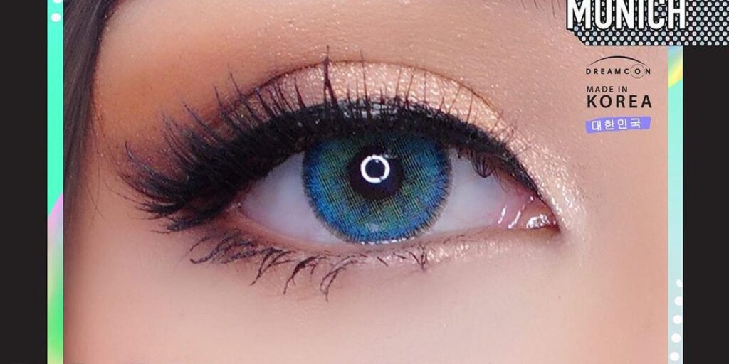 Dreamcolor Ocean Blue monthly colored contacts on dark eyes showing electric blue-teal with multi-tonal depth for vivid striking look