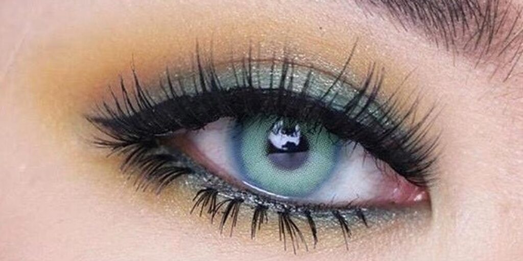 Pitchy Sweety Spatax Blue monthly colored contacts on dark eyes showing vivid blue-green teal with gradient from mint outer to deep blue center