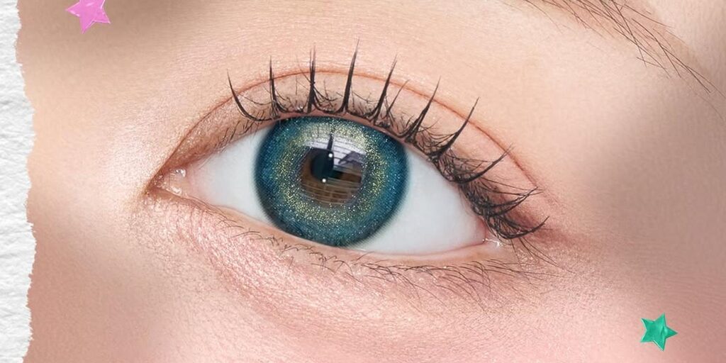 Manylens Angie Ocean Blue monthly colored contacts on dark eyes showing deep teal with gold-bronze shimmer for jewel-like editorial look