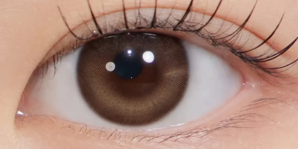 Hapa Kristin One and Only Beige colored contacts on dark eyes showing warm creamy beige with golden honey undertones for natural warmth