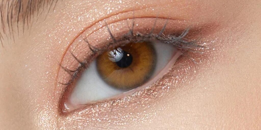 OLENS Scandi Hazel colored contacts on dark eyes showing cool sage-green hazel with Nordic-inspired clean finish